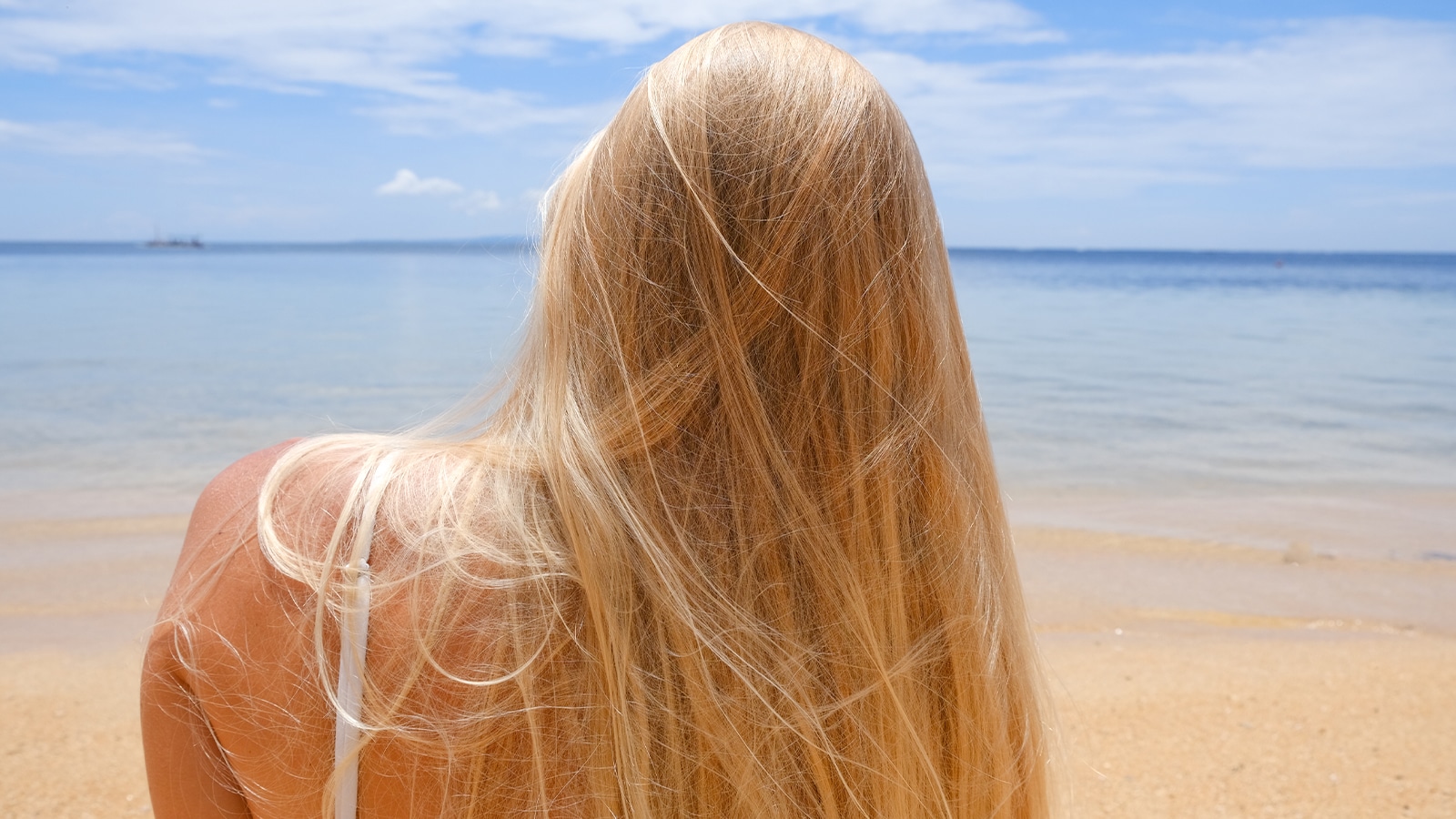 Woman with hair extensions at the beach