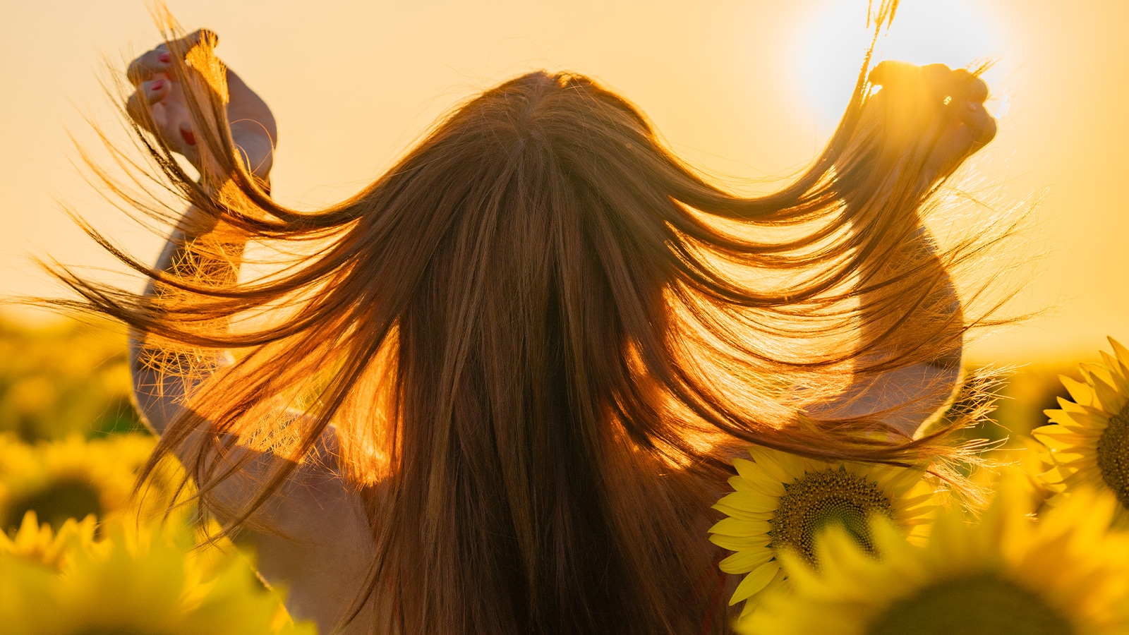 Woman with hair extensions standing in the sun